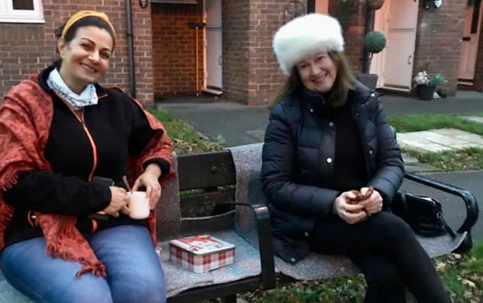 Sue and Layla having a socially distant lockdown coffee outside on a bench
